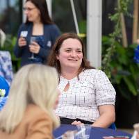 Shelby Harrison chatting with two coworkers